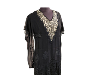 Black silk chiffon dress with lace applique on V neckline with nude under-lying fabric.