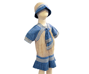 White and blue cotton children's sailor dress with matching cap.